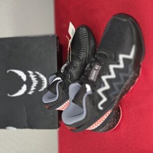 Black and Red Sneakers with Unique Lacing and Breathable Upper